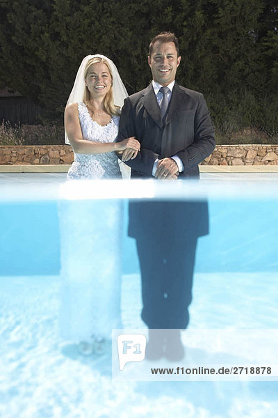 Wedding couple standing in pool