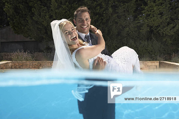 Bräutigam mit Braut im Pool