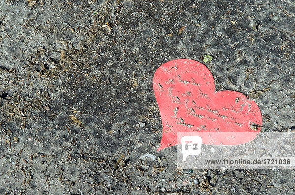 Red Paper heart on ground  elevated view