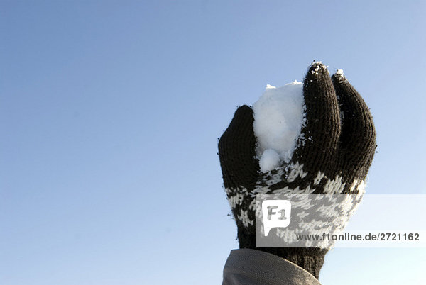 Human hand holding snowball  close-up