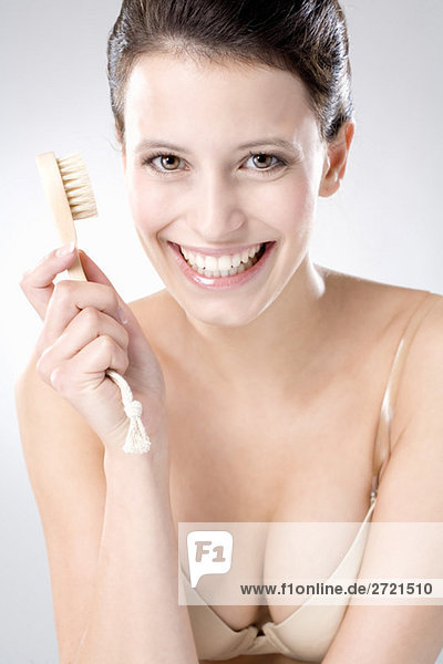 Young woman using peeling brush  close up