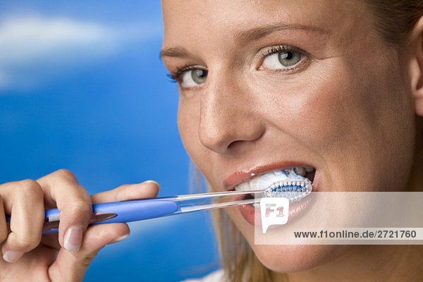Young woman brushing teeth  portrait