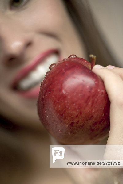 Young woman holding apple  close-up