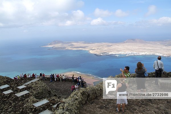 High angle view of tourists standing at observation point  Lanzarote  Canary Islands  Spain