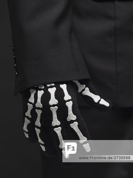 A person wearing a skeleton glove