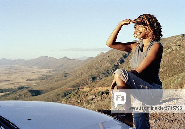 A young woman looking across an arid landscape