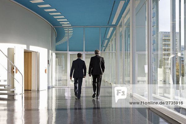 Two businessmen walking towards the exit
