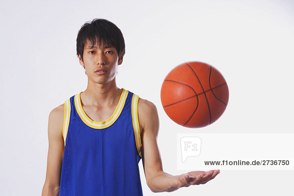 Chinese young man with basketball