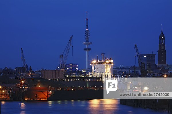 Lit up port at dusk  Hamburg  Germany