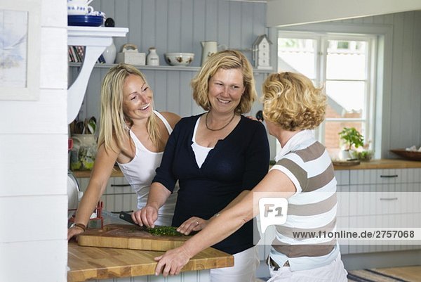 Three happy women in a kitchen