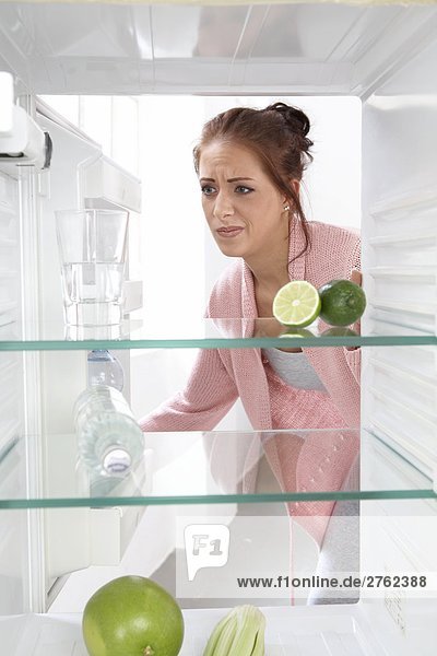 woman looking into an empty cooler