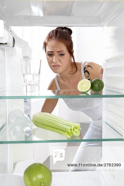 woman looking into an empty cooler
