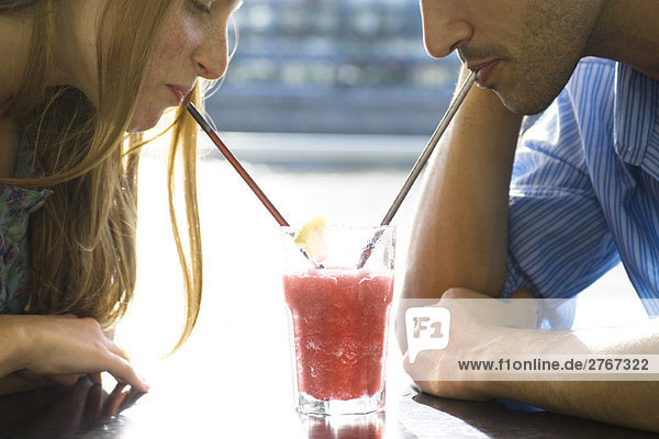 Couple sharing cool drink  cropped