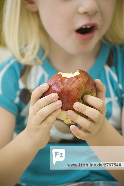 Kleines Mädchen isst Apfel  gepflanzt