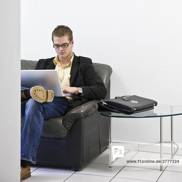 Man on laptop in office