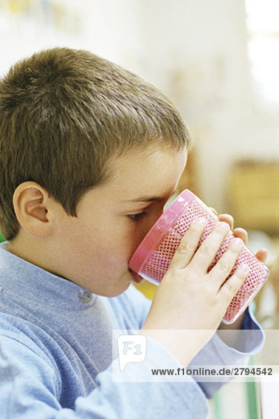 Child drinking from plastic cup  side view