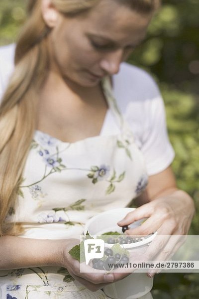 Woman holding blackcurrants