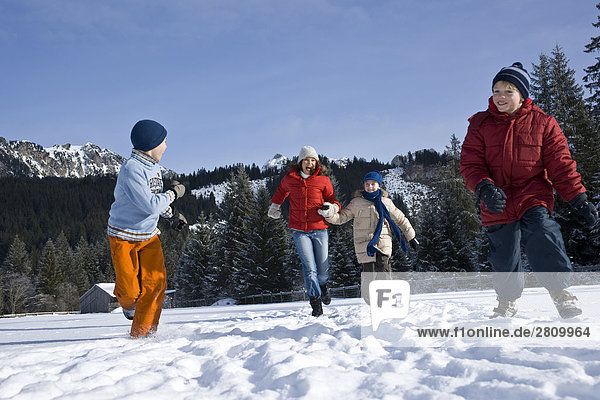 Tourists enjoying in snow covering landscape