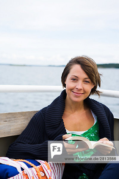 A Scandinavian woman in a boat in the archipelago Sweden.