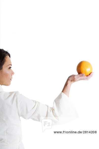 Woman holding an orange Sweden.