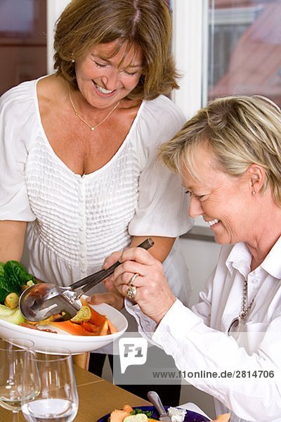 Two smiling mature women during a dinner Sweden.