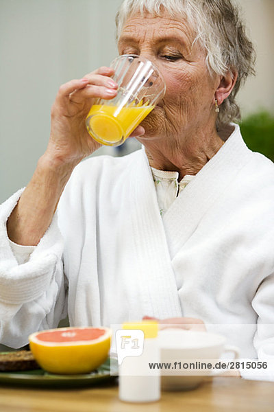 An elderly woman taking her medicine Sweden.