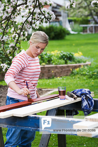 A woman painting in the garden Sweden.