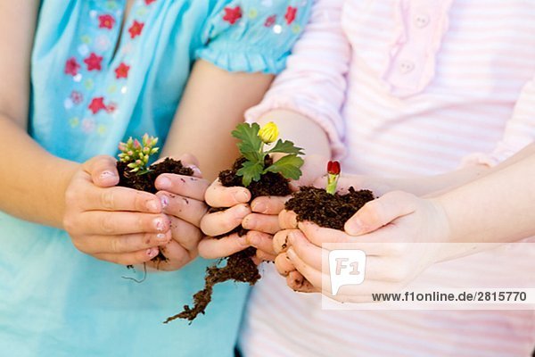 Two girls holding flowers.