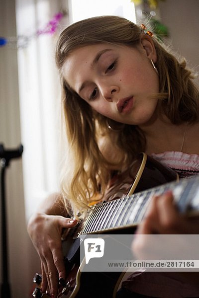 A girl playing the guitar Sweden.