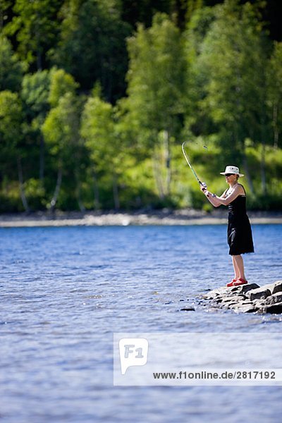 A woman fishing Jamtland Sweden.