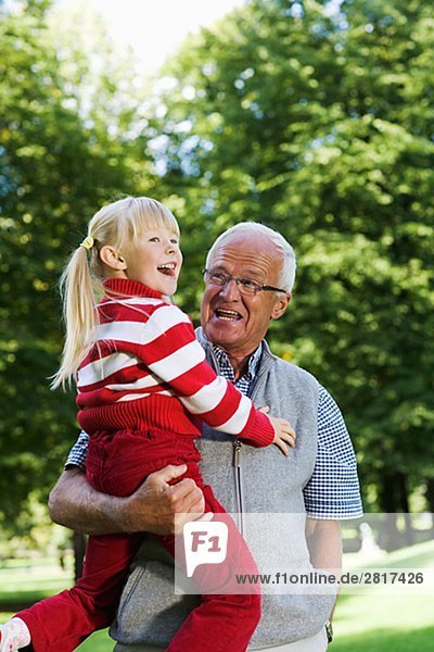 A girl with her grandfather in the park Sweden.