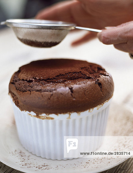 Chocolate soufflé and cocoa powder