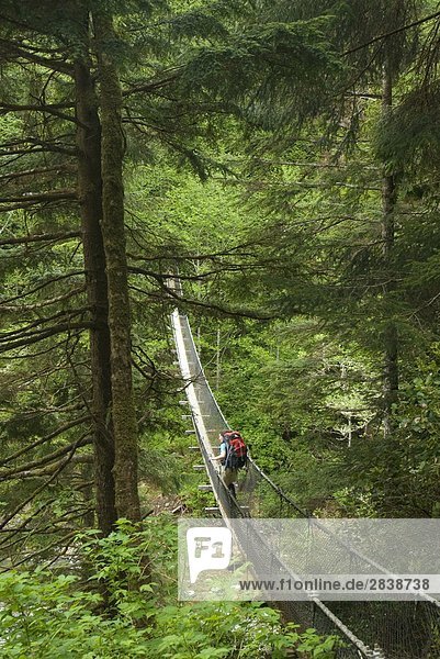 Crossing the Logan Creek Suspension Bridge  West Coast Trail  Pacific Rim National Park Reserve  Vancouver Island  british columbia  canada.