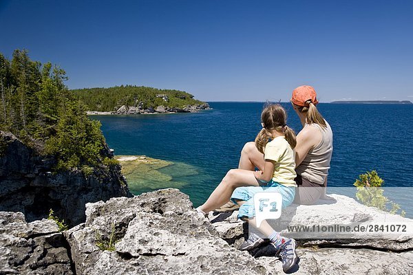 Young mother and daughter enjoy view at The Grotto along Bruce Trail  Bruce Penninsula National Park  near Tobermory  Ontario  Canada.