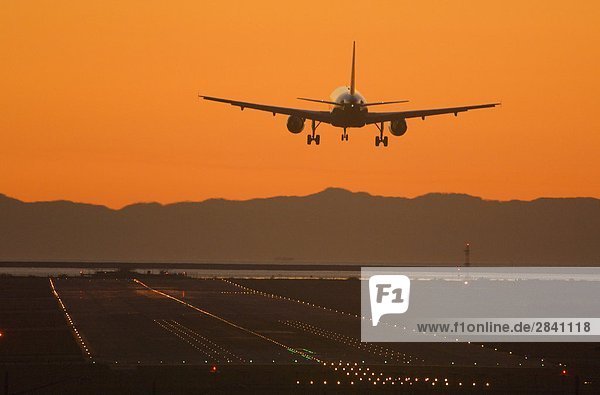 Plane taking off during sunset at Vancouver International Airport  Vancouver  British Columbia  Canada.