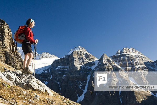 A female hiker above Moraine Lake and the Valley of the Ten Peaks en route to Sentinel Pass  Alberta  Canada.