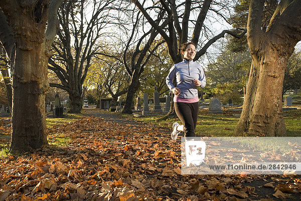 A female runner at the Ross Bay Cemetery in Victoria  British Columbia  Canada.