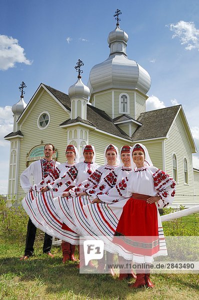 Ukrainian dancers pose in front of St.Vladimir's Ukrainian Greek Orthodox Church in the Ukrainian Cultural Heritage Village  east of Edmonton  Alberta  Canada