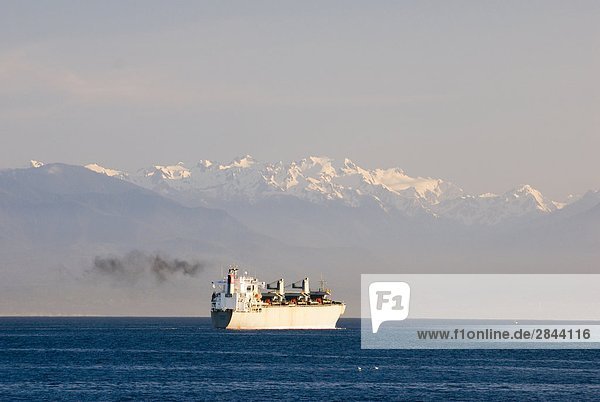 Cargo ship on the Strait of Juan de Fuca  the principal outlet for the Georgia Strait and Puget Sound  connecting both to the Pacific Ocean  British Columbia  Canada
