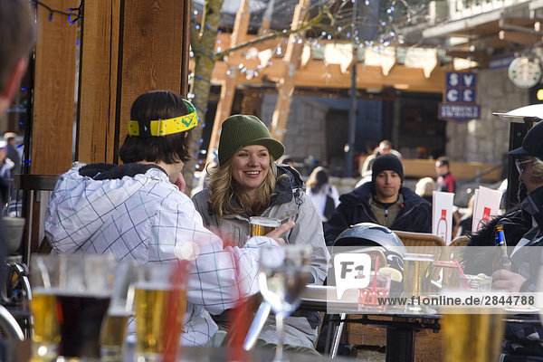 Young adults enjoy an after ski drink  Whistler Village  British Columbia  Canada