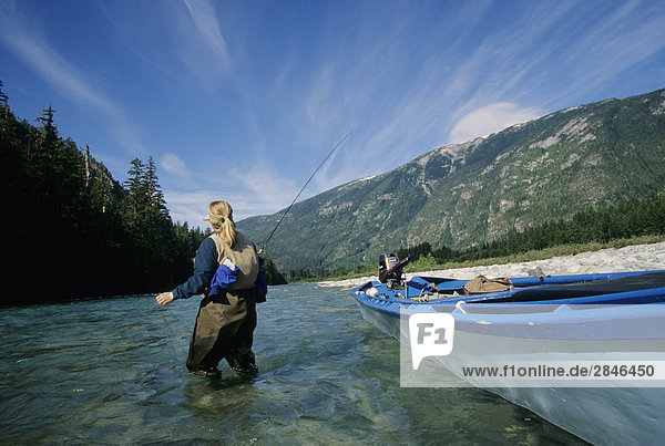 Lady flyfisher fishing for steelhead  Dean river  British Columbia  Canada.