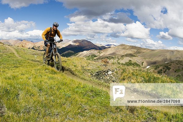 Mountain biker rides the trail up to Deer Pass  Southern Chilcotin Mountains  British Columbia  Canada.