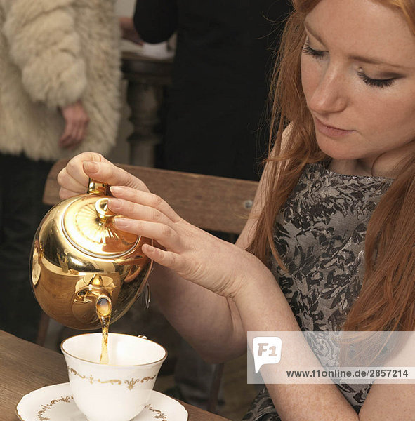Young woman having tea in café