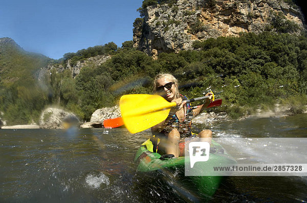 Young girl doing kayak on a river
