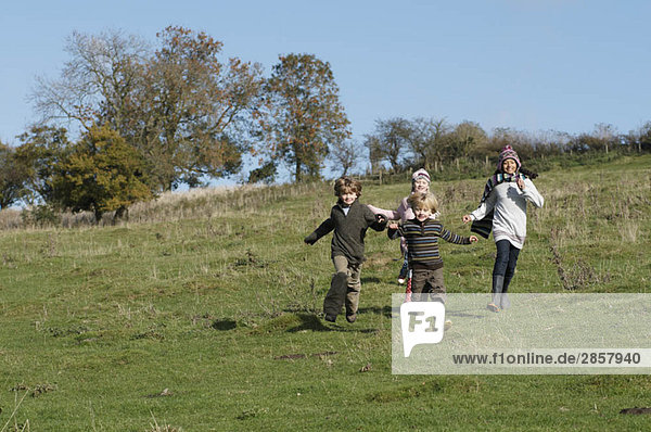 Children running in countryside