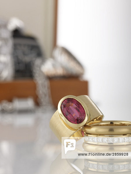 Two rings in foreground,  in the background jewel box