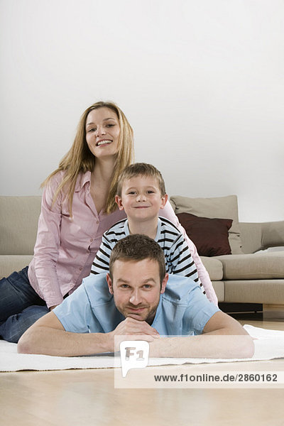 Parents and son (4-5) at home  smiling  portrait