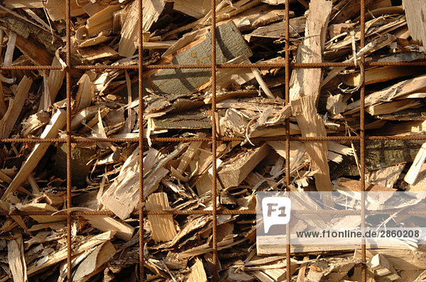 Firewood behind fence  close-up