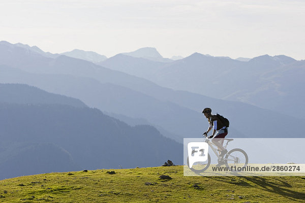 Austria  Salzburger Land  Zell am See  Woman mountain biking