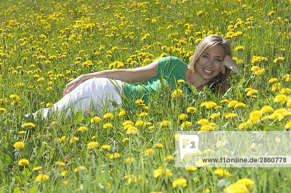 Austria  Salzburger Land  Young woman relaxing in meadow